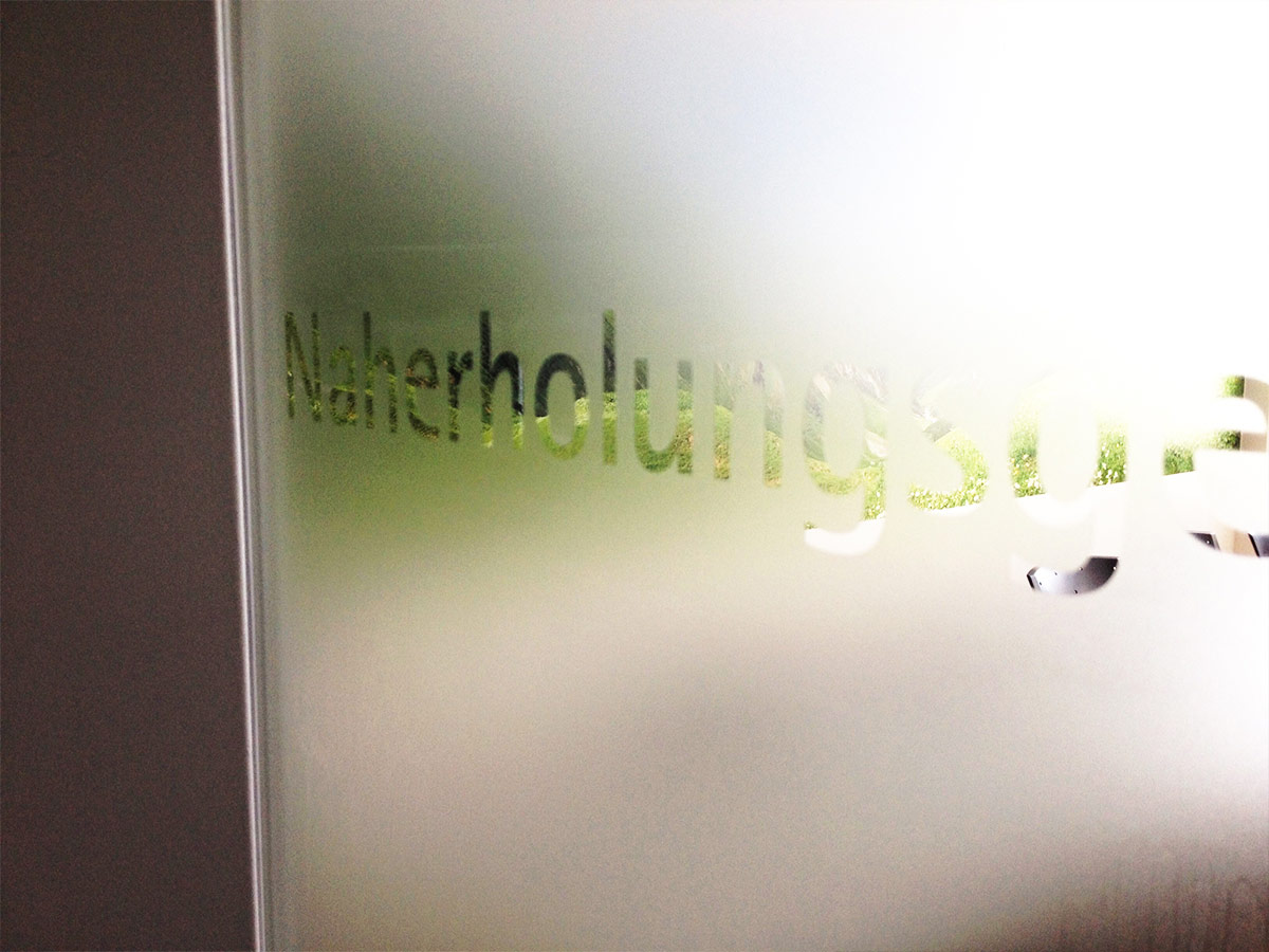 Glastür kaschiert Schriftzug negativ ausgeschnitten
